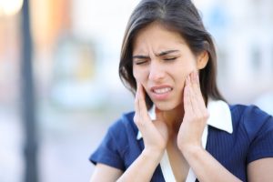 woman suffering from tmj disorder pain